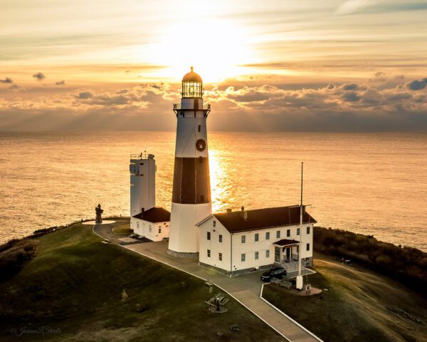 A lighthouse with the sun setting behind it.