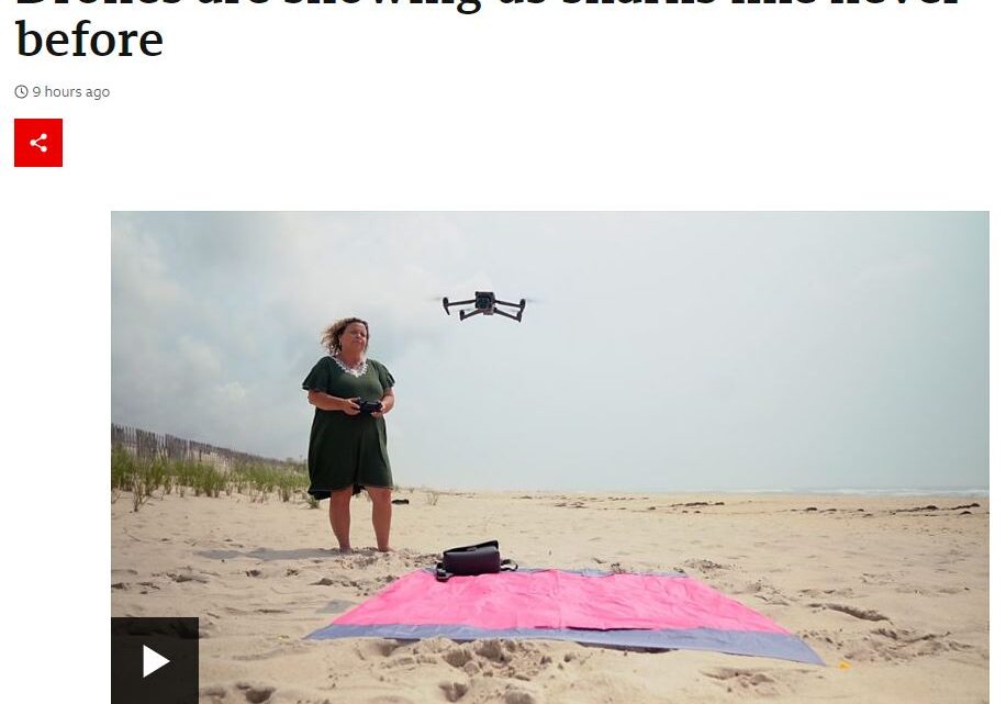 A woman on a beach with a drone