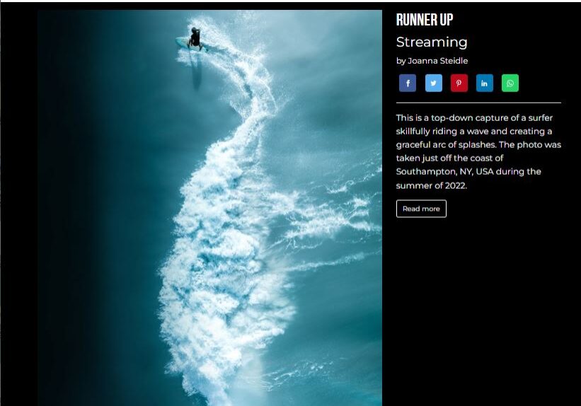 An aerial view of a surfer riding a wave